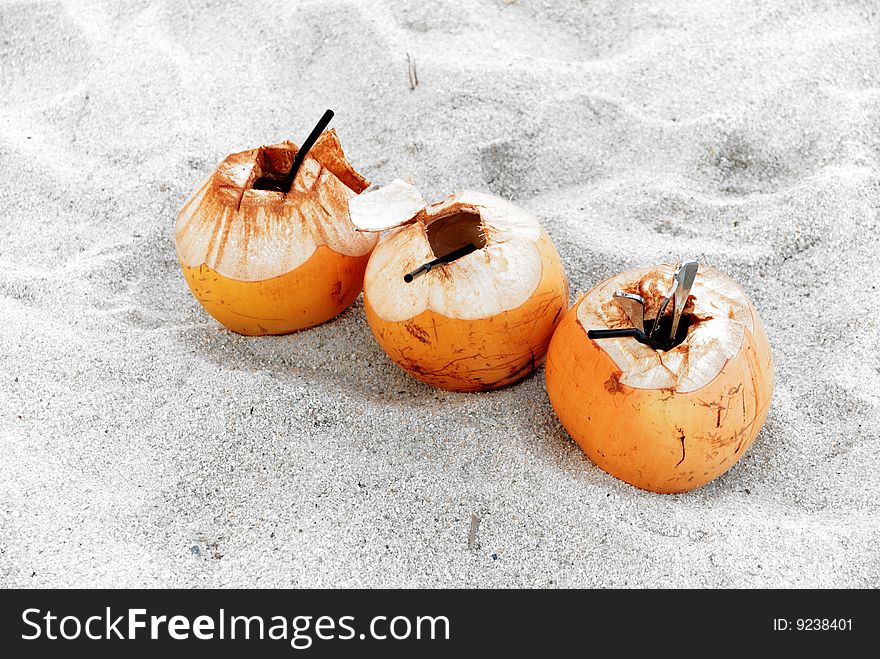 Three fresh coconut drink leave on beach