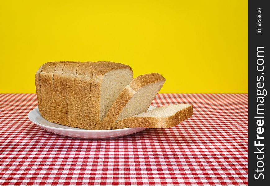 A loaf of sliced bread served on a platter. A loaf of sliced bread served on a platter.