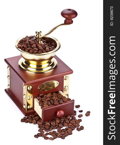 Old-fashioned coffee grinder and coffee beans on a white background. Old-fashioned coffee grinder and coffee beans on a white background