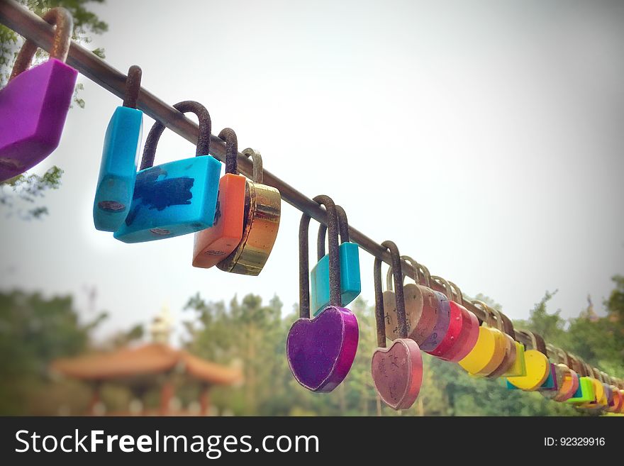 A love lock or love padlock is a padlock which sweethearts lock to a bridge, fence, gate, or similar public fixture to symbolize their love. Typically the sweethearts&#x27; names or initials are inscribed on the padlock, and its key is thrown away to symbolize unbreakable love. Since the 2000s, love locks have proliferated at an increasing number of locations worldwide. They are now mostly treated by municipal authorities as litter or vandalism, and there is some cost to their removal. However, there are authorities who embrace them, and who use them as fundraising projects or tourism attractions. A love lock or love padlock is a padlock which sweethearts lock to a bridge, fence, gate, or similar public fixture to symbolize their love. Typically the sweethearts&#x27; names or initials are inscribed on the padlock, and its key is thrown away to symbolize unbreakable love. Since the 2000s, love locks have proliferated at an increasing number of locations worldwide. They are now mostly treated by municipal authorities as litter or vandalism, and there is some cost to their removal. However, there are authorities who embrace them, and who use them as fundraising projects or tourism attractions.