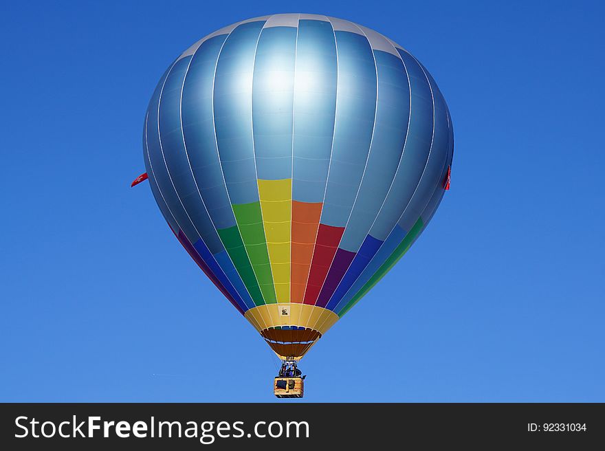 Hot Air Balloon Flying Against Blue Sky