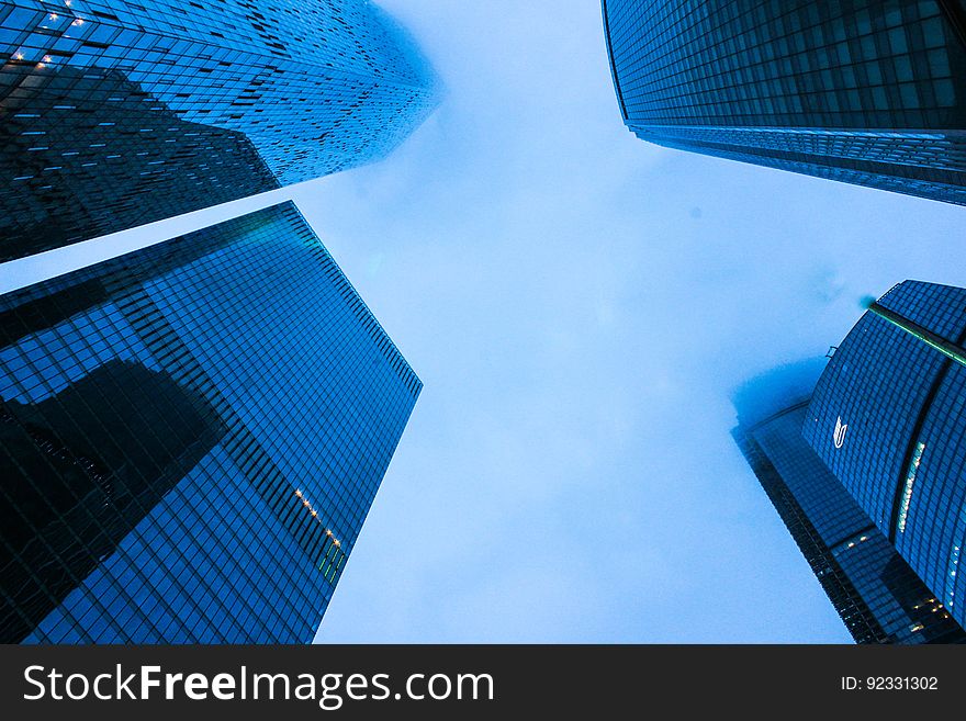 A street view of tall skyscrapers in the city. A street view of tall skyscrapers in the city.