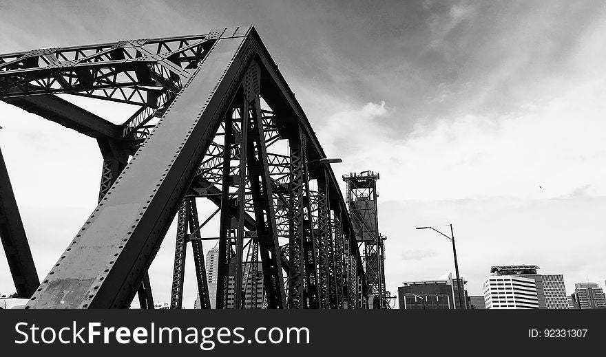 A steel bridge in the city in black and white.