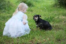 A Little Girl With A Dog In The Summer Garden Royalty Free Stock Image
