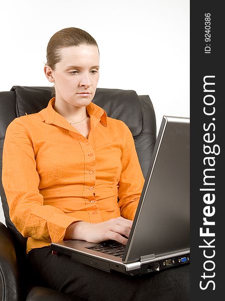 Young woman working on laptop on white ground