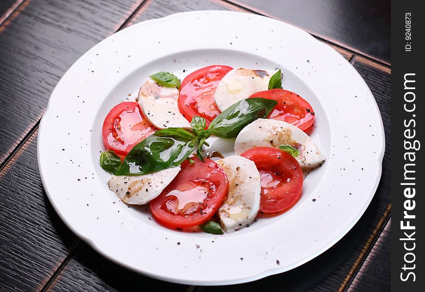 Salad with cheese, tomatoes and basil. Salad with cheese, tomatoes and basil.