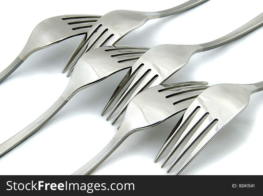 Metallic forks on white background