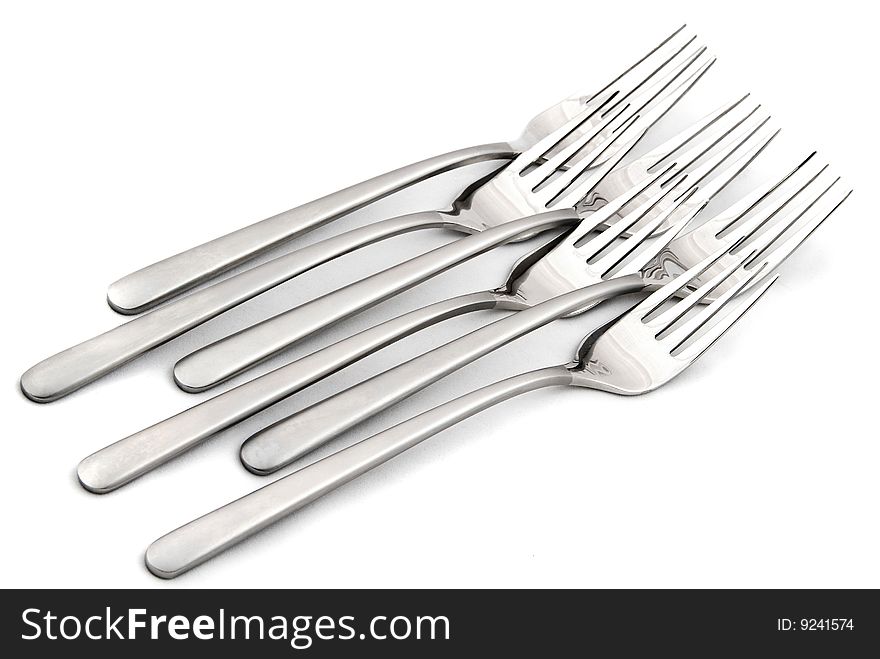 Metallic forks on white background