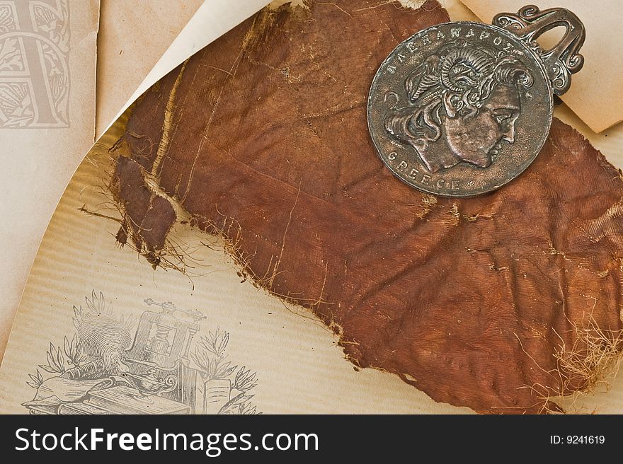 Ornamental background with old paper and ancient holder for a paper. Ornamental background with old paper and ancient holder for a paper