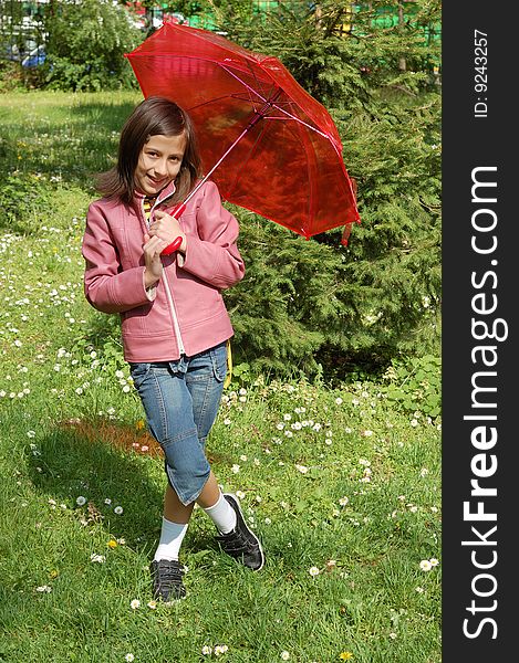 Little girl with a red umbrella having fun in park. Little girl with a red umbrella having fun in park