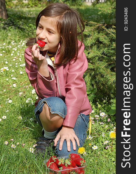 Happy young girl holding strawberries. Happy young girl holding strawberries.