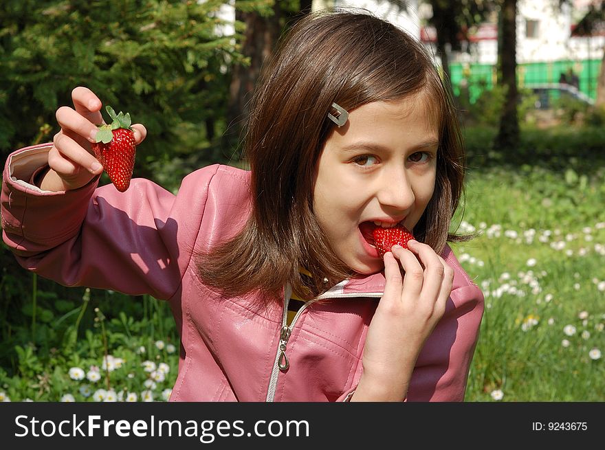 Happy young girl holding strawberries. Happy young girl holding strawberries.