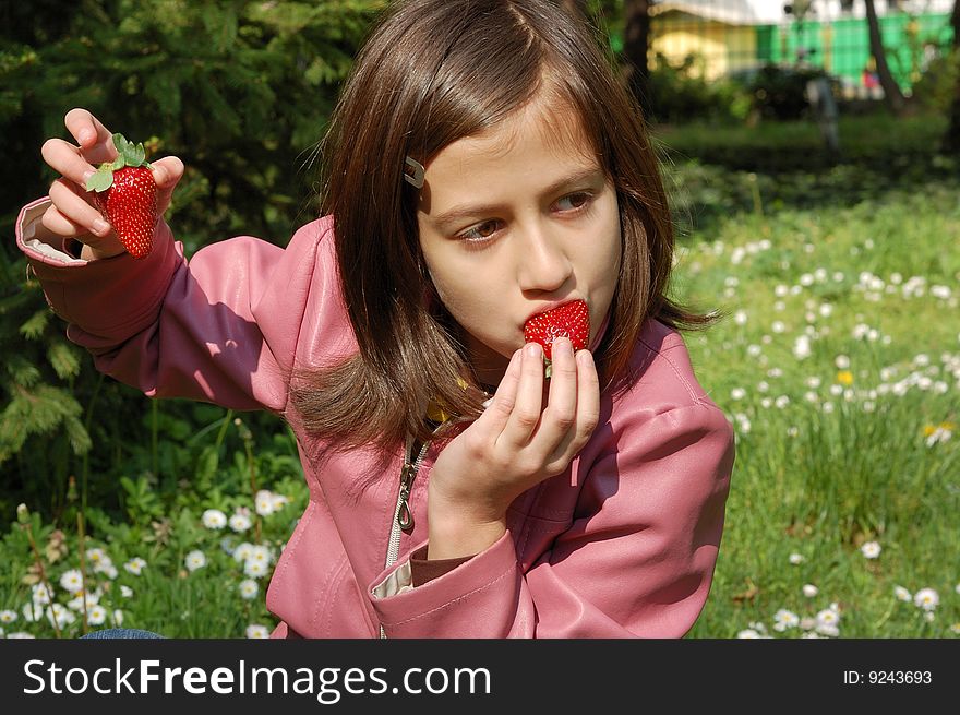 Happy young girl holding strawberries. Happy young girl holding strawberries.