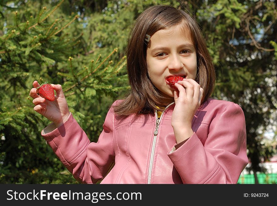 Happy young girl holding strawberries. Happy young girl holding strawberries.