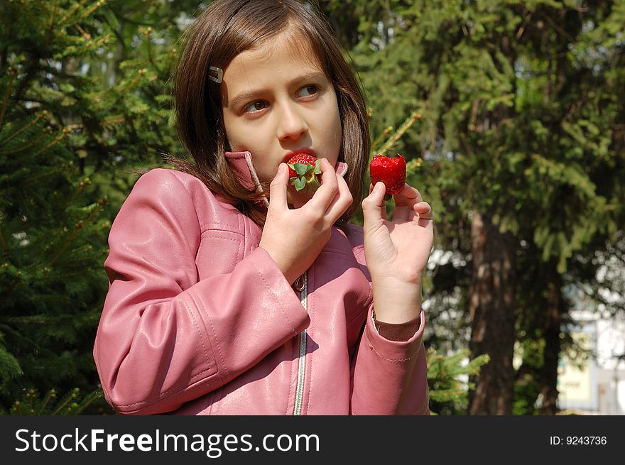 Happy young girl holding strawberries. Happy young girl holding strawberries.