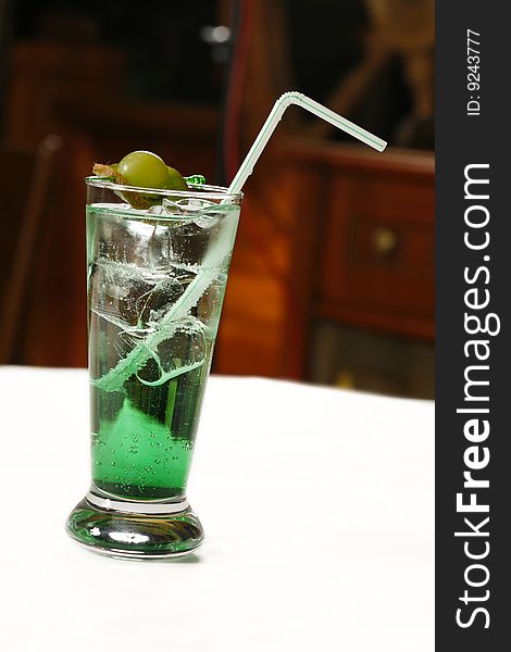 Green alcoholic cocktail with berries. Green alcoholic cocktail with berries