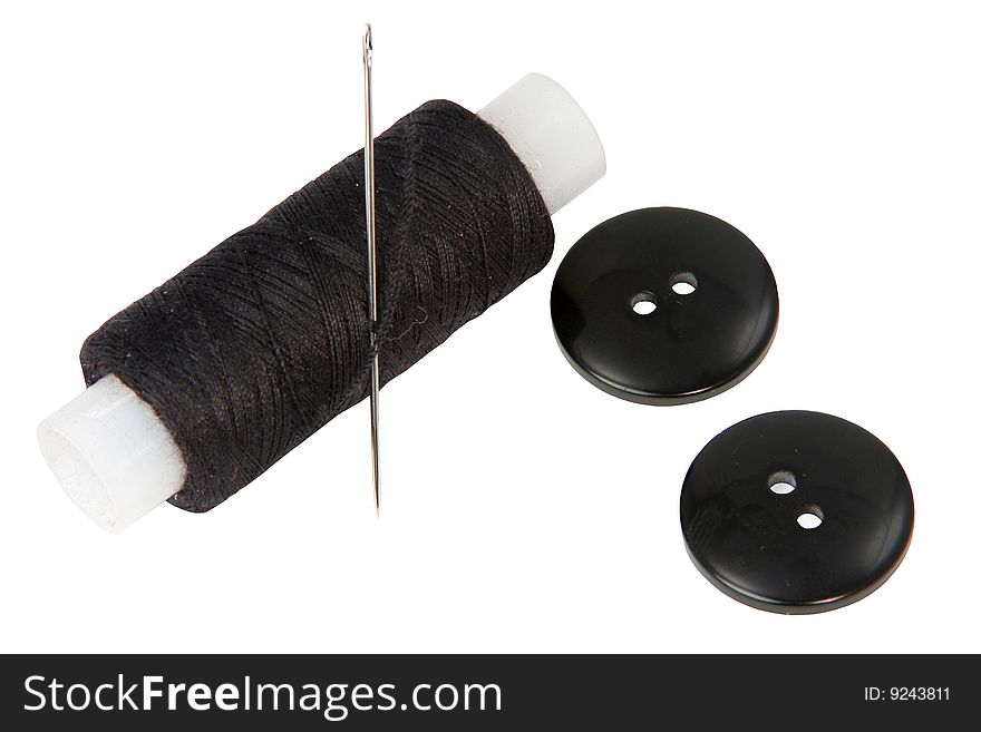 The coil of black threads with a needle on a white background. The coil of black threads with a needle on a white background