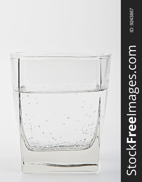 Glass with water on a white background. Glass with water on a white background