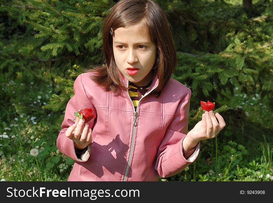 Happy young girl holding strawberries. Happy young girl holding strawberries.