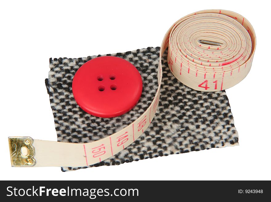 The sample of a fabric with a button and a measured tape on a white background