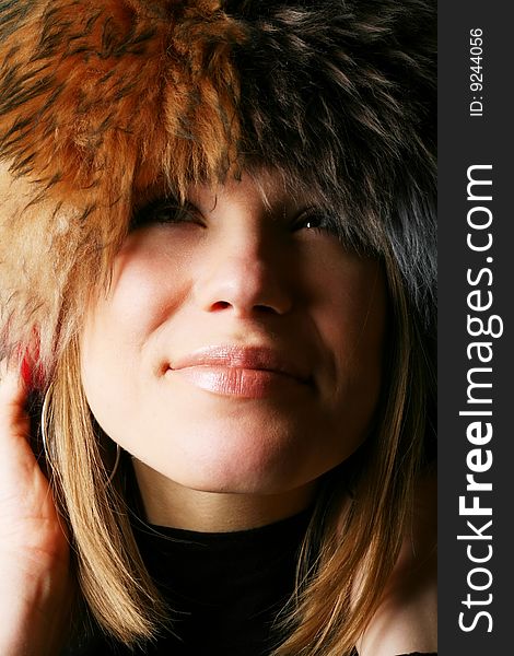 Portrait of a beautiful girl in a fur hat