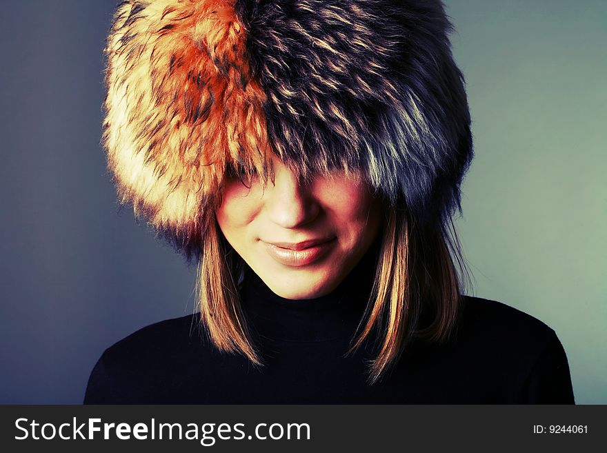 Portrait of a beautiful woman in a fur hat. Portrait of a beautiful woman in a fur hat