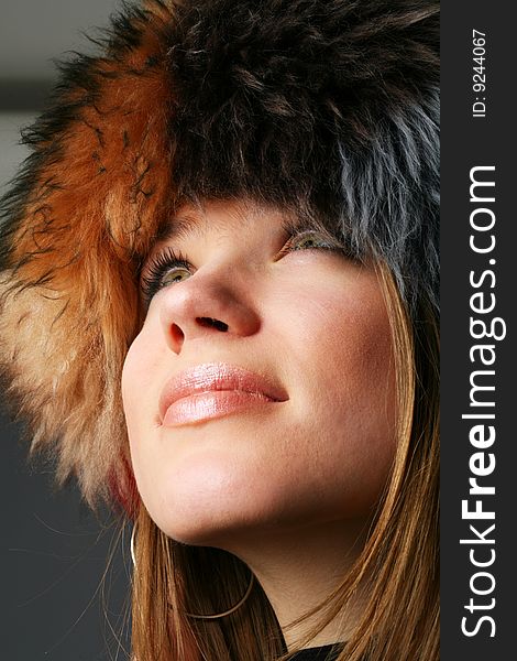 Portrait of a beautiful woman in a fur hat. Portrait of a beautiful woman in a fur hat