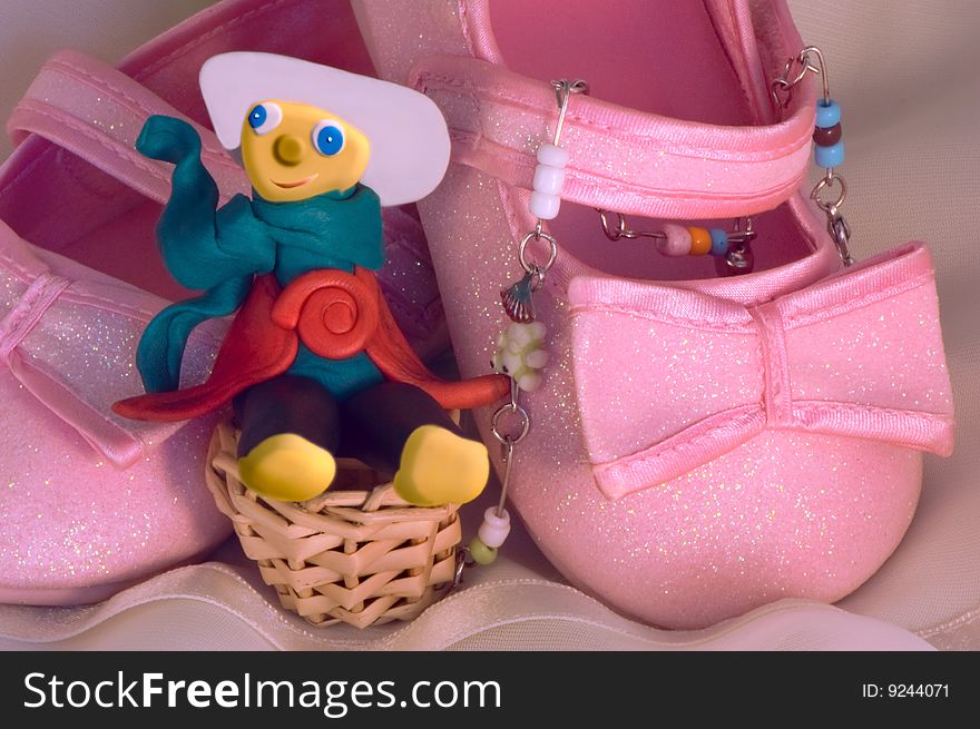 Plasticine Toy And Pink Shoes For A Baby