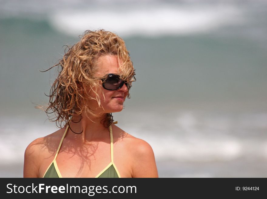 Windswept girl standing  on beach. Windswept girl standing  on beach