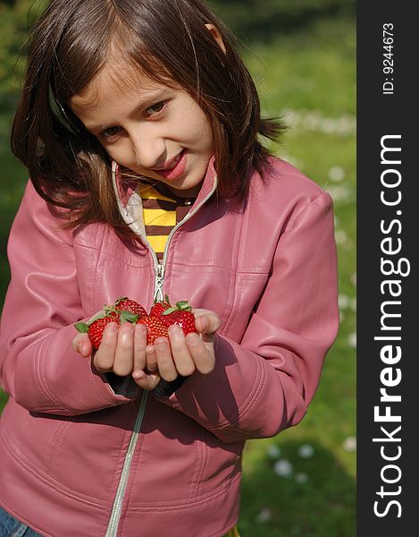 Happy young girl holding strawberries. Happy young girl holding strawberries.