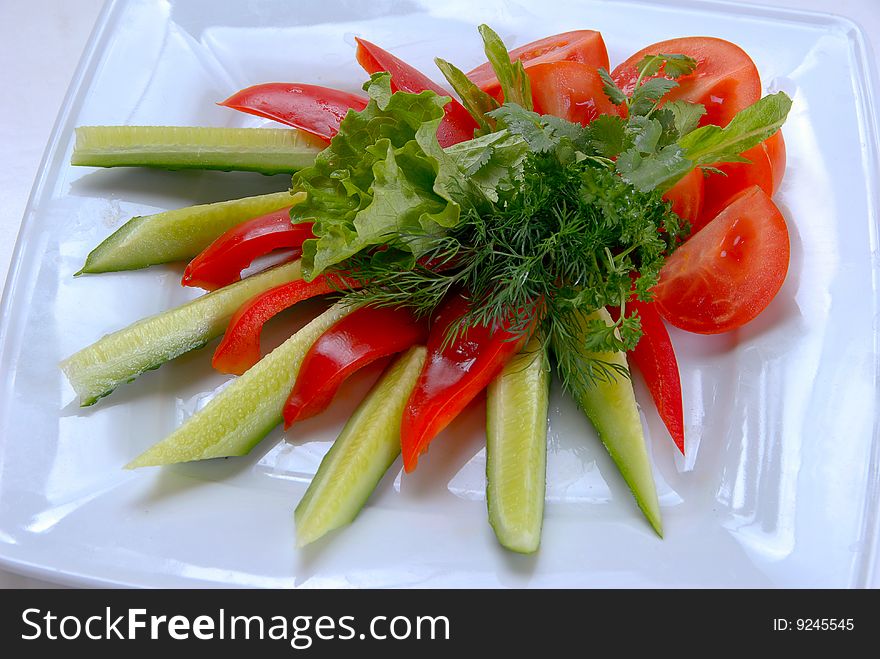 Salad peppers tomatoes and cucumbers with lettuce