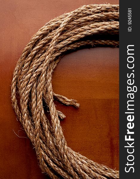 A coil of rope on a wooden surface