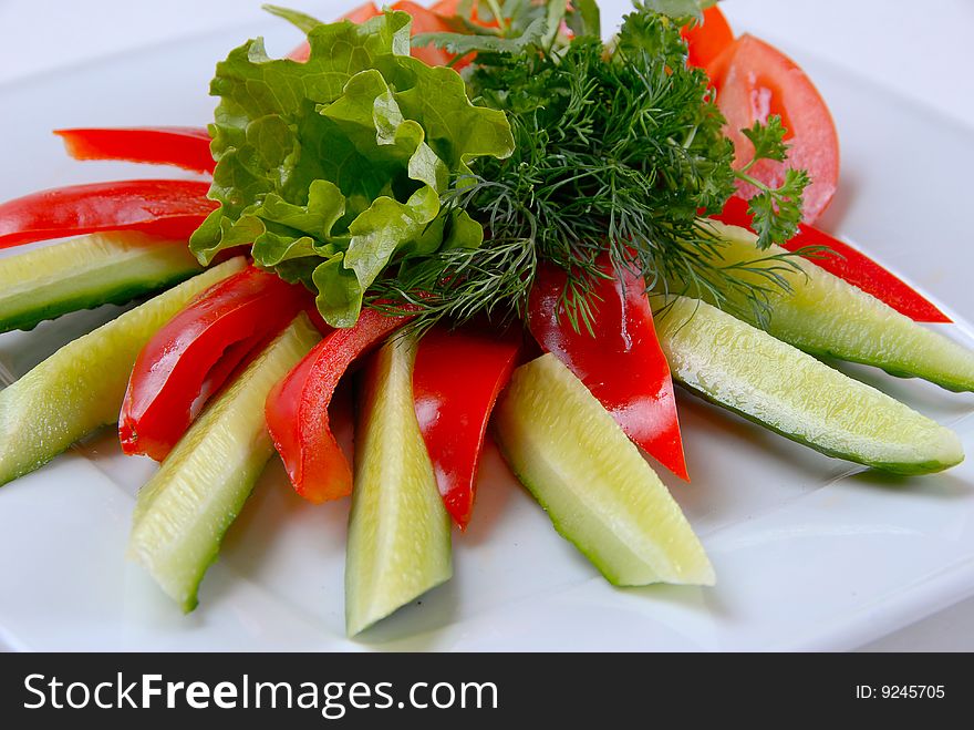 Salad peppers tomatoes and cucumbers with lettuce