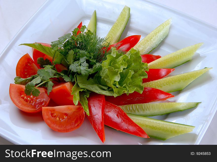 Salad peppers tomatoes and cucumbers with lettuce