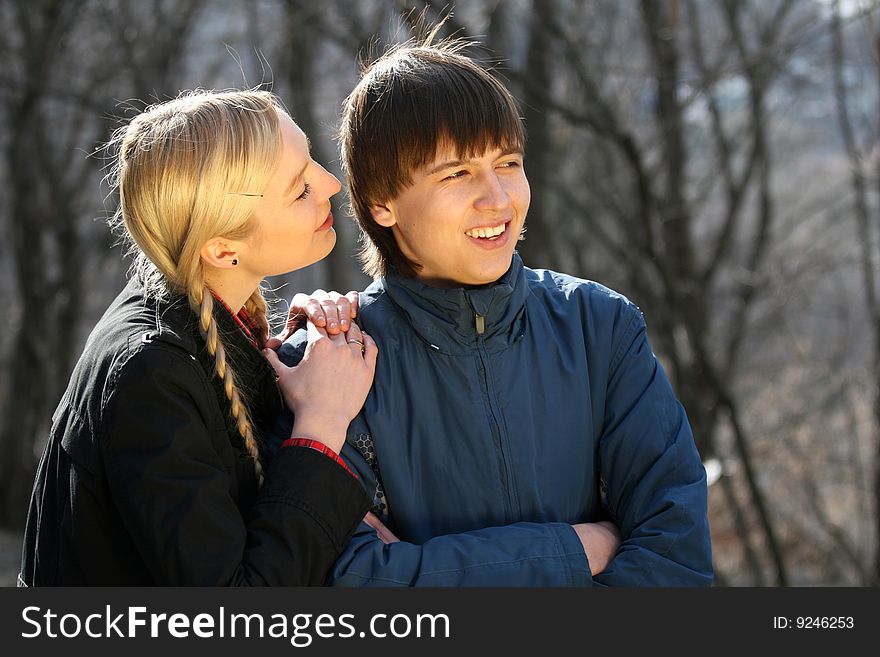 Two young teenagers talking in the park