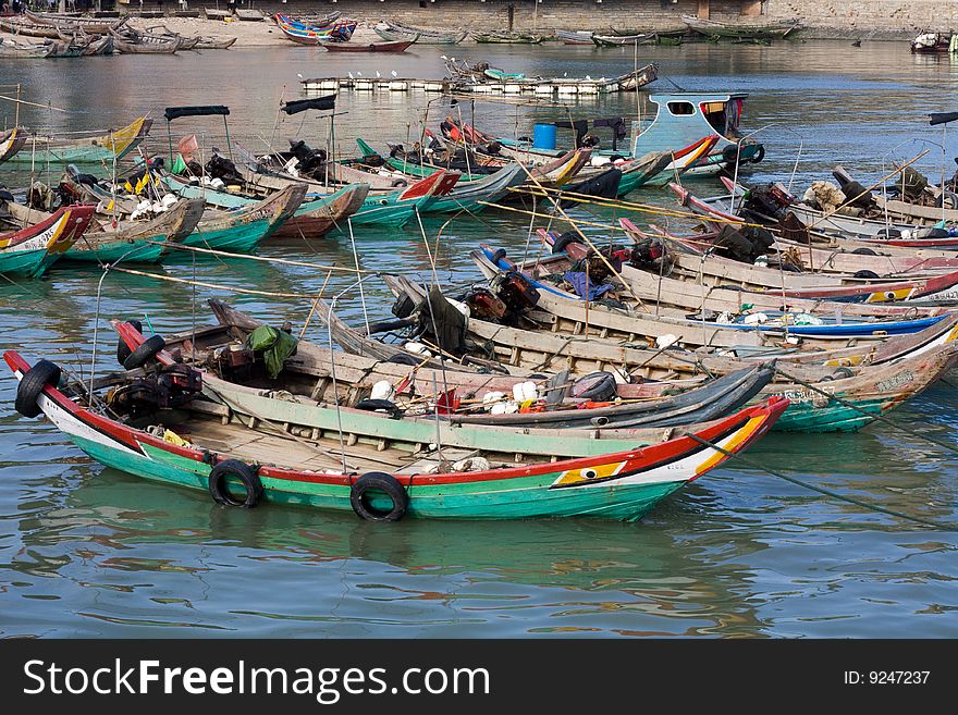 Chinese fishing boats tied together and lined-up. Chinese fishing boats tied together and lined-up