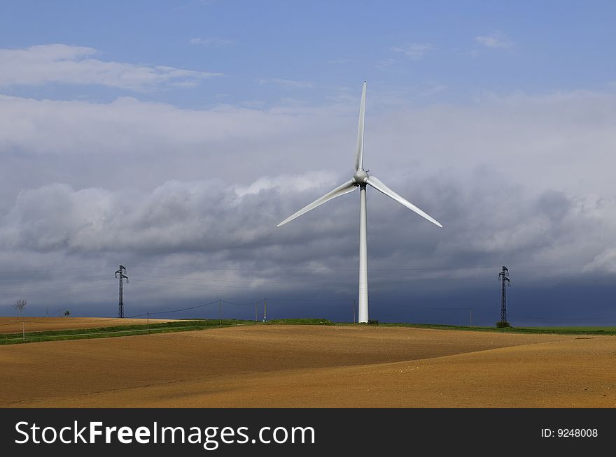 Lonely wind turbine in a field. Lonely wind turbine in a field