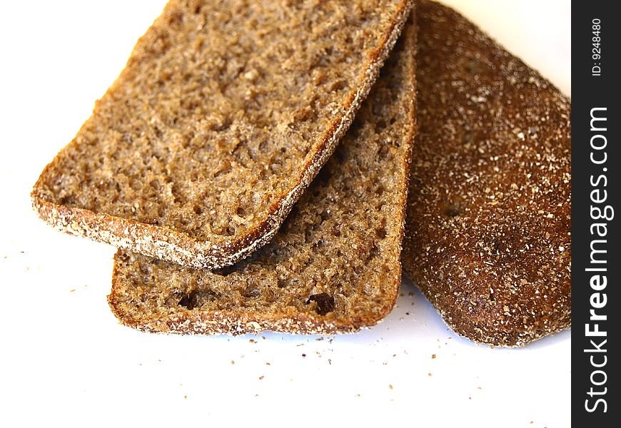 Three slices of rye bread on white background