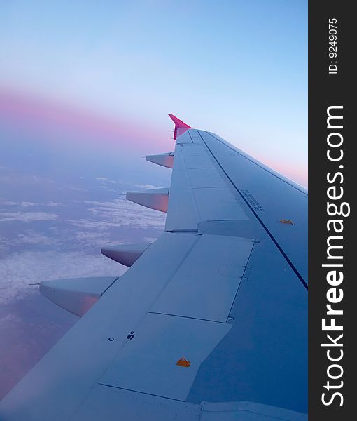 Plane wing on blue sky background