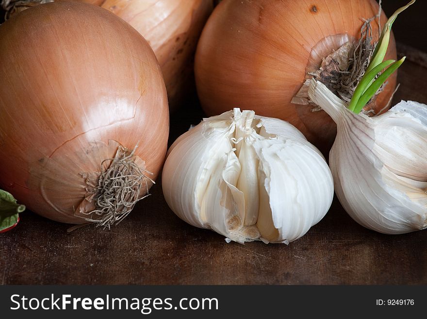 Garlic and onions on dark wooden background