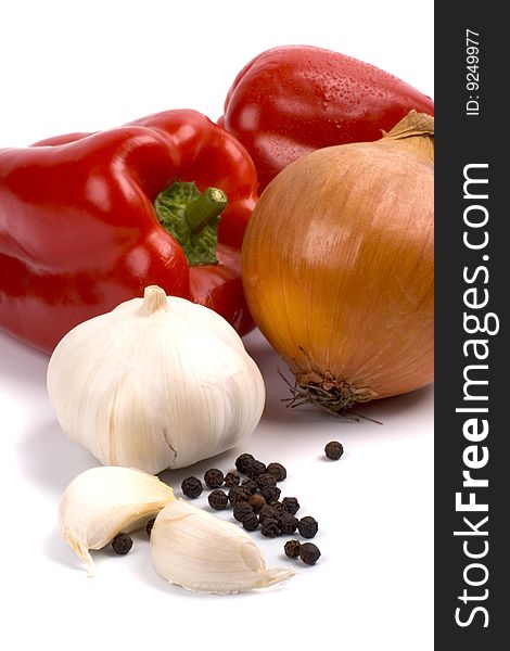 Paprika, onion and garlic closeup on white background. Paprika, onion and garlic closeup on white background