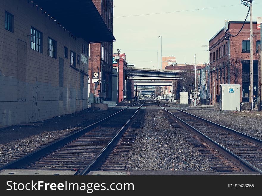Empty railroad tracks in a city.