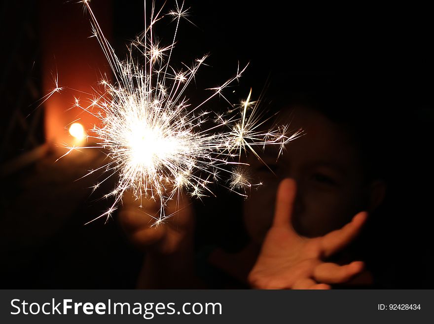 A person holding a sparkler.