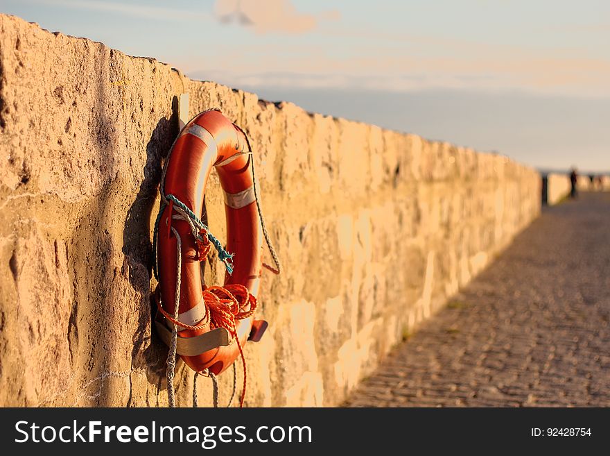 Life buoy hanging on a wall at a beach.