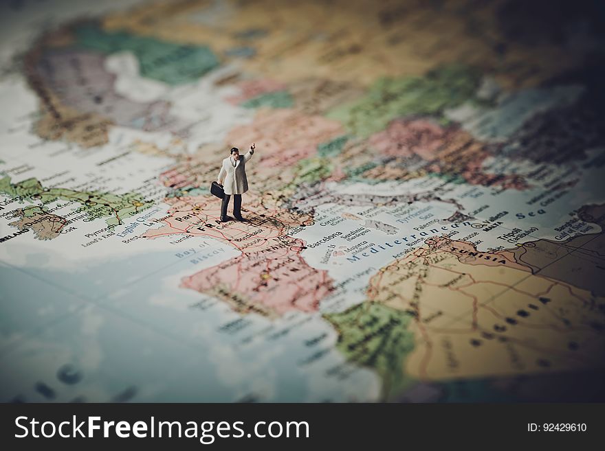 A miniature figure of a traveler on the map of Europe. A miniature figure of a traveler on the map of Europe.