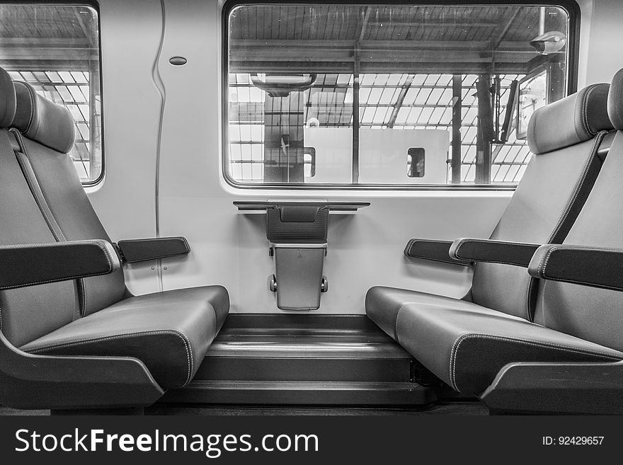 Standard seating with arm rests and head rests in a passenger train stationary in a station. Standard seating with arm rests and head rests in a passenger train stationary in a station.