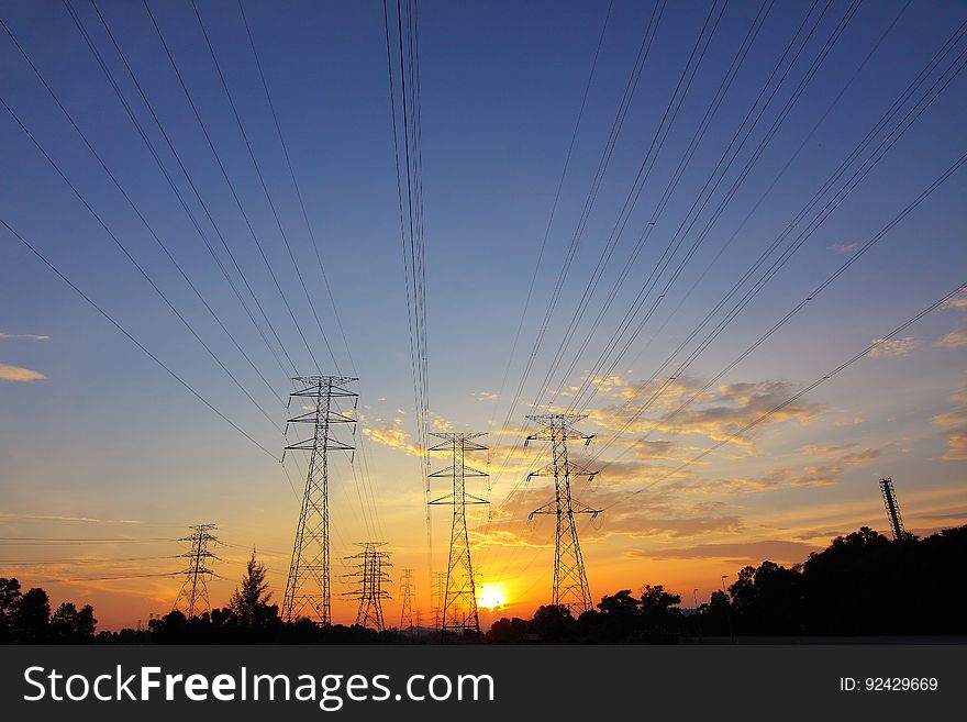 Silhouette of high voltage transmission towers.