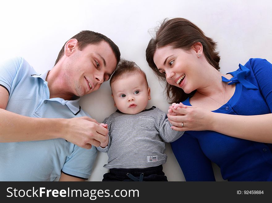Man Beside Baby and Woman