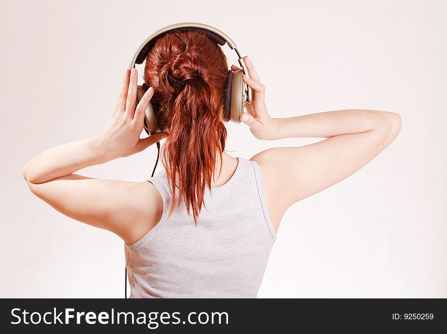 Young girl with big headphones listening to music