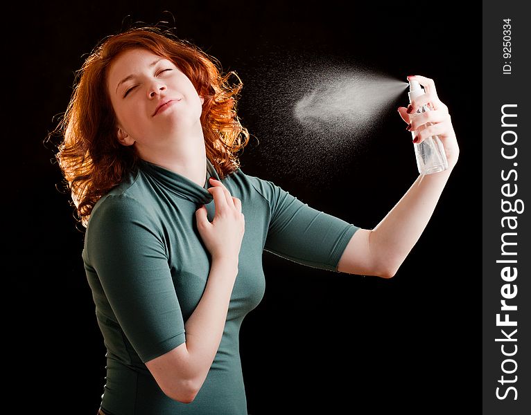 Girl with red hair holding a spray. Girl with red hair holding a spray